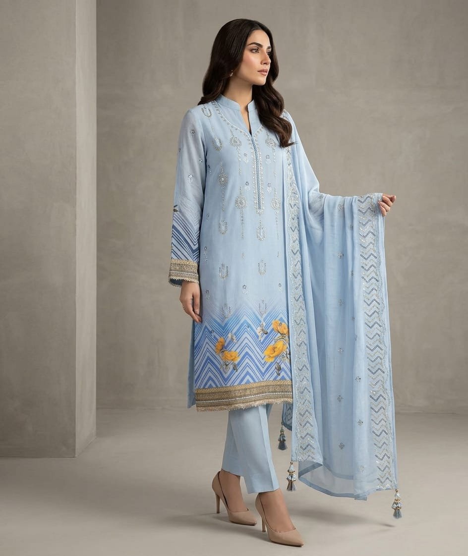 Ice Blue Sequins Embroidered 3 Piece Suit Ice blue sequins embroidered 3 piece suit with yellow floral daman print and embroidered dupatta by Maham Clothing